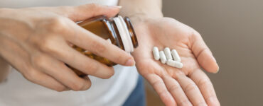 wellness scam - pills in hand
