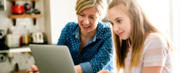 mom and daughter using computer