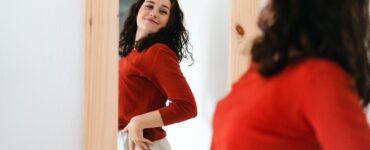 body positivity - woman looking in mirror