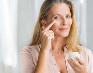 woman putting on face cream
