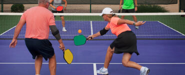 get better at pickleball - group playing pickleball