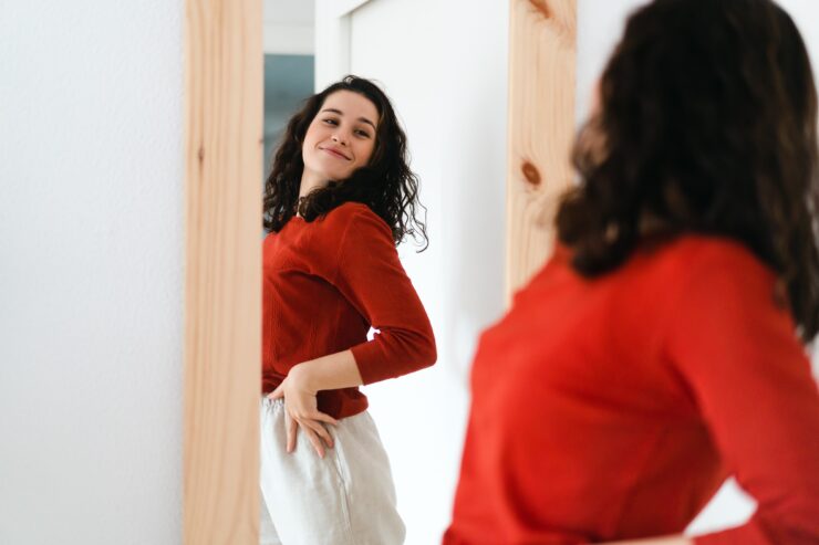 body positivity - woman looking in mirror