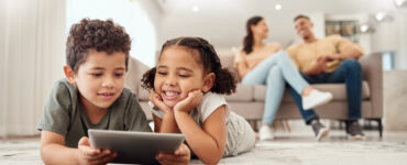 smart streaming - kids using tablet with parents in background