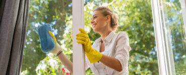 cleaning tricks - woman cleaning glass