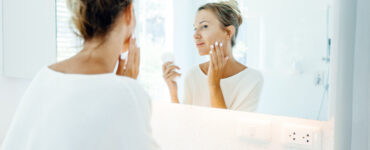 daily sunscreen - woman looking in mirror