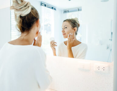 daily sunscreen - woman looking in mirror