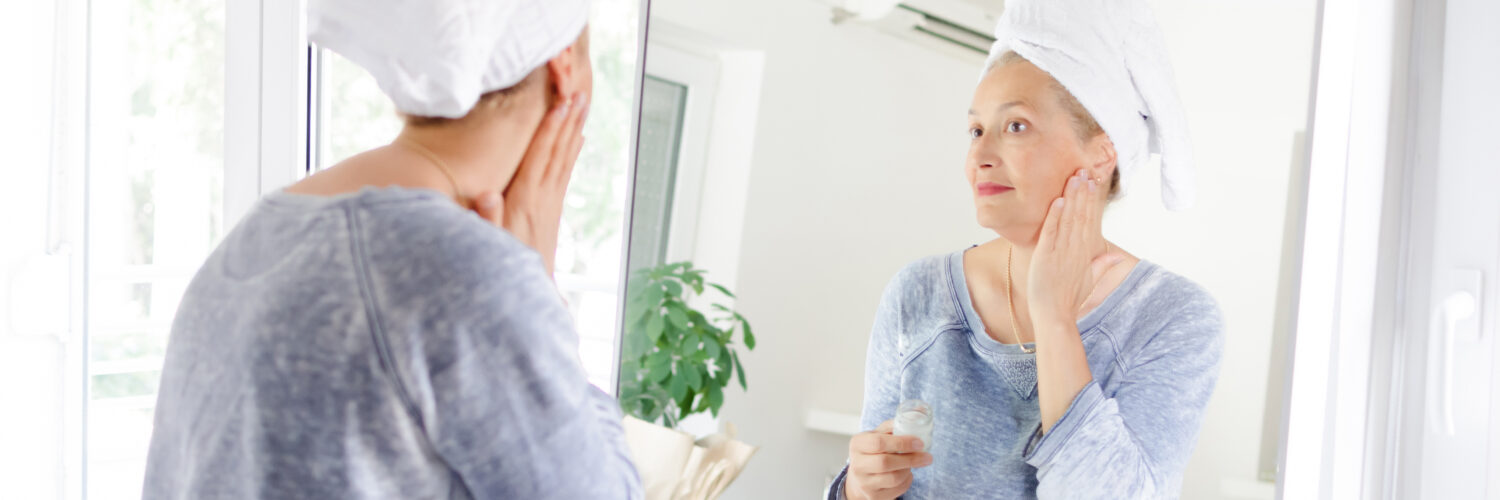 aging well - woman looking in mirror