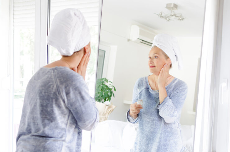 aging well - woman looking in mirror
