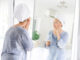 aging well - woman looking in mirror