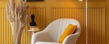chair and lamp sitting area with yellow wall